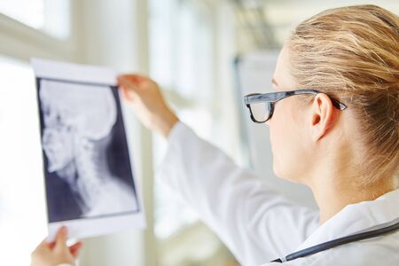 Doctor with x-ray image in radiology analyzing diagnose for patient