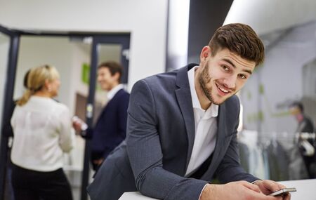 Businessman using social media on his smartphone
