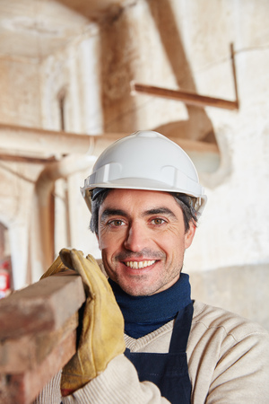 Man as construction worker at carpentry shopの写真素材