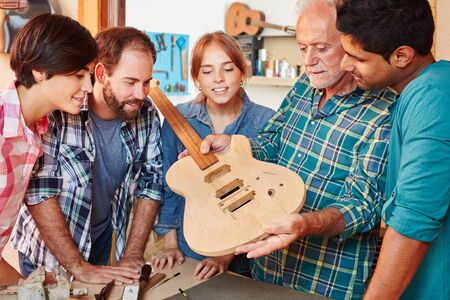 Team of apprentice and luthier in guitar lessonの写真素材