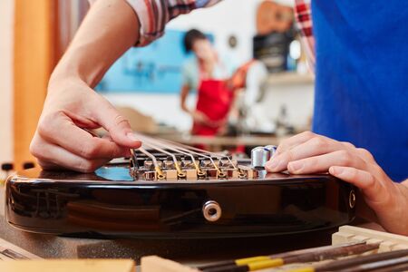 Electric guitar reparation at luthier's workshopの写真素材