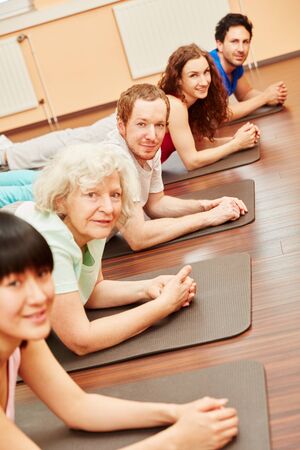 Pilates class with active senior woman at fitness centerの写真素材