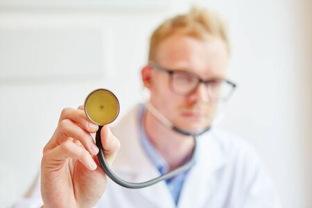 Doctor with stethoscope for giving health diagnosesの写真素材