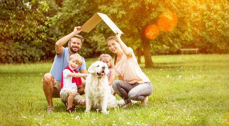Family with roof over their heads as house construction goal conceptの写真素材