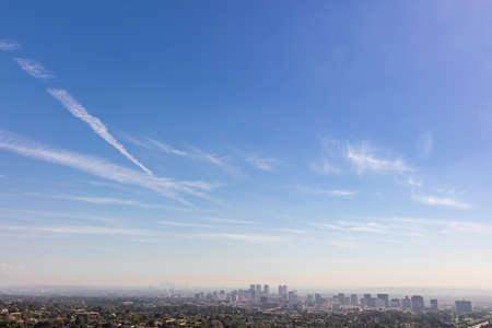 Blue sky with some clouds over Los Angeles skyline with skyscrapersの写真素材
