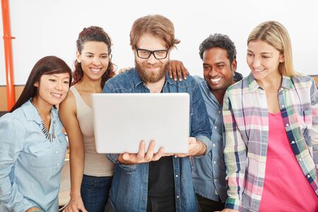 Startup team with laptop using internet for social media communication