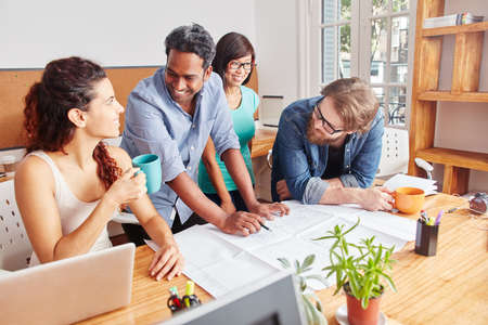 Startup team discussing project planning in a meetingの写真素材