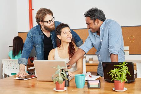 Founder and team with laptop in startup consulting agency