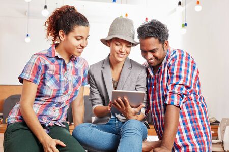 Startup team with tablet using social media for cooperation creative teamwork