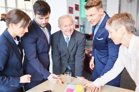 Group of business people in business meeting cooperating in teamwork
