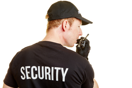Bodyguard alarms his team with a radio during a mission