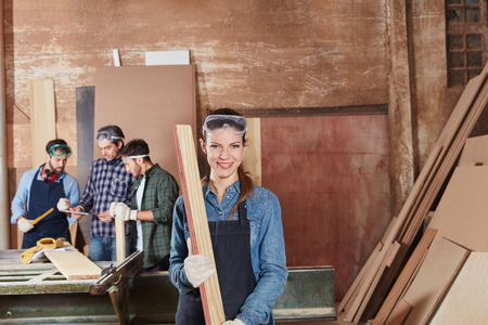Woman as carpentry apprentice working with woodの写真素材