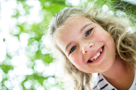 Happy girl's face with tooth space smiling in summer 