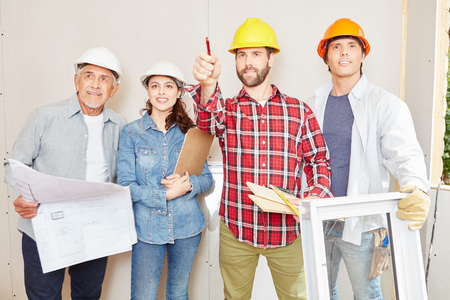 Group of craftsmen as team working and planning building constructionの写真素材