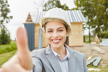 Young joyful architect holdingthumbs upの写真素材