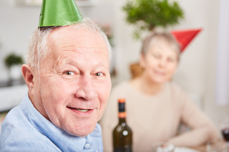 Senior in new year's eve celebration with party hatsの写真素材