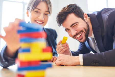 Business colleagues in team building workshop building blocksの写真素材