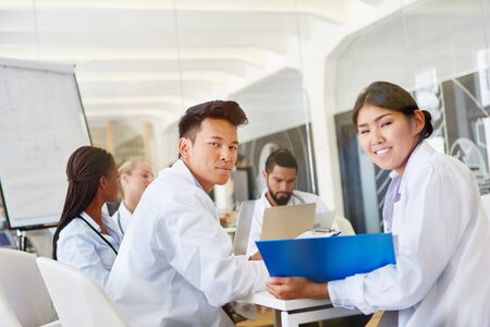 Students in medical school seminar learn together in cooperation