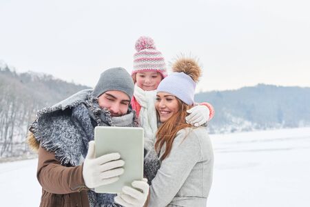 Family takes a selfie in their winter holiday tripの写真素材