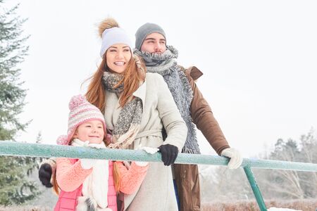 Happy family with daughter in winter holidaysの写真素材
