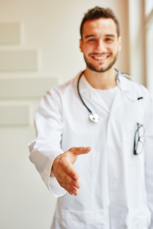 Doctor giving handshake to the cameraの写真素材