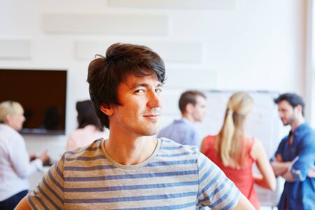 Young businessman thinking about his start-up company and looking satisfiedの写真素材