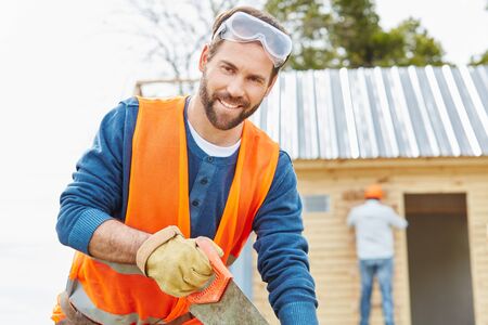 Carpenter working on building new house の写真素材