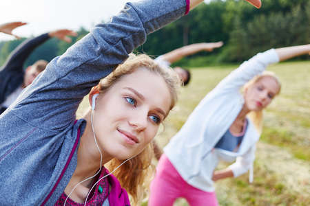 Group of women in fitness training stretching their bodyの写真素材
