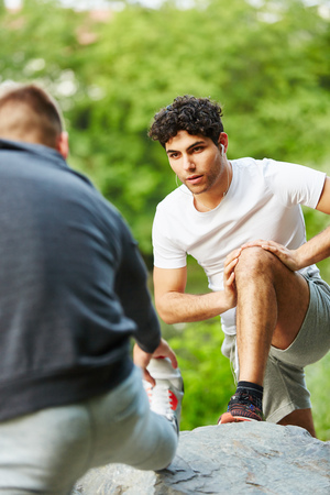 Young men stretching and warming up before raceの写真素材
