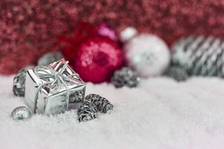 Christmas gift in the snow as decoration for greeting cardの写真素材