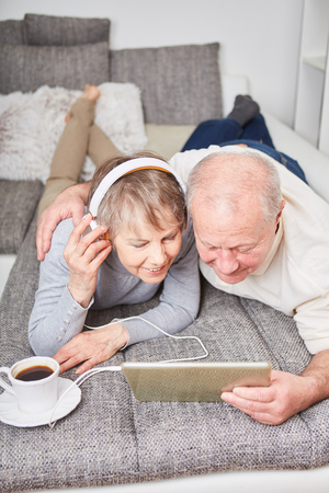 Seniors listen to music together with streaming app on tabletの写真素材