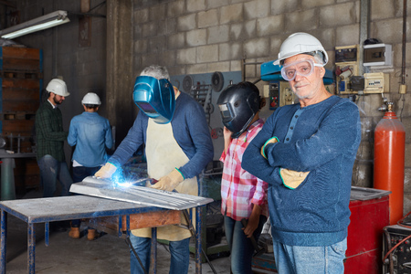 Senior craftsman or artisan in welding workshop as master worker