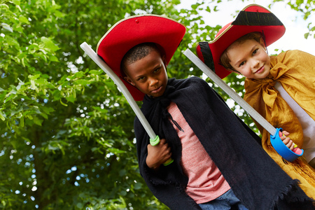 Two young kids dressed up like knights playing as friendsの写真素材