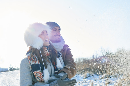 Couple in winter taking a walk and laughingの写真素材