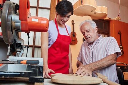 Carpenter as guitar making instructor of apprentice or traineeの写真素材