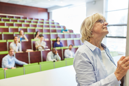 Senior woman as math lecturer in university lecture hallの写真素材