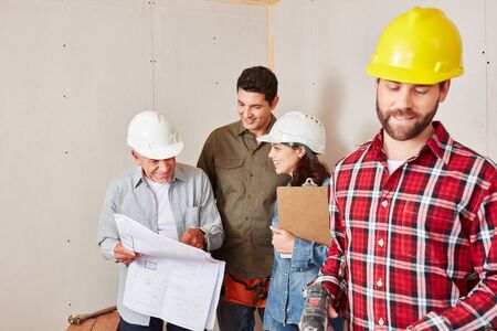 Craftsmen group as a team planning with architectural drawing