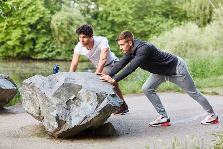 Young man stretching excercises at the parkの写真素材