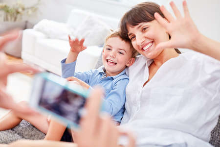 Mother and son pose for a snapshot with the smartphone camera