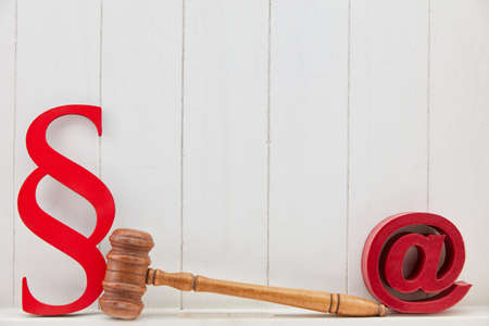 Email symbol as a media law and IT law concept against a wooden backgroundの写真素材