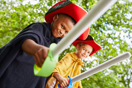 Interracial duet of kids as pirates in carnivalの写真素材