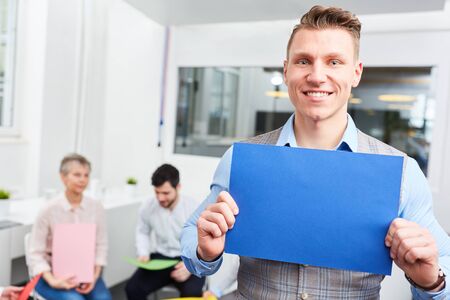 Joung start-up man holds blank page during creative brainstorming at officeの写真素材