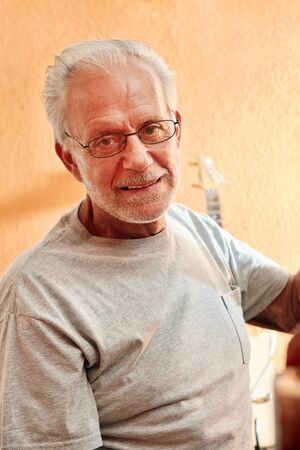 Senior man as luthier at his workshop