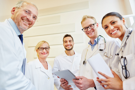 Team of successful doctors smiling happy at hospitalの写真素材