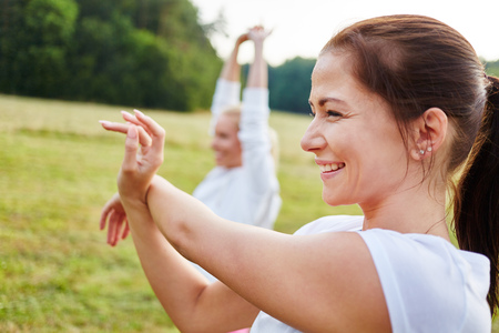 Vital women stretching with joy and working outの写真素材