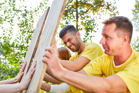Young team trains confrontation and strength in a teamwork workshopの写真素材