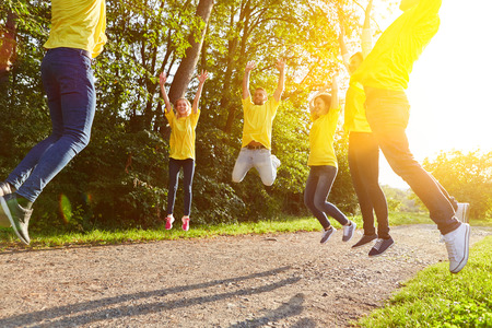 Team fitness by jumping in the group as teambuilding eventの写真素材