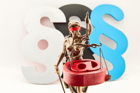 Internet law concept with blind justice with scales and at signs and paragraphsの写真素材