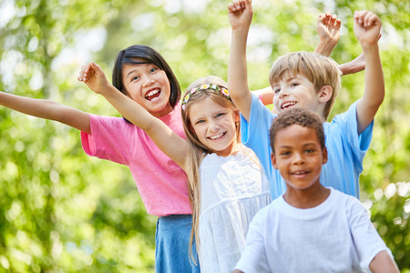 Multicultural kindergarten group is looking forward to summer in natureの写真素材