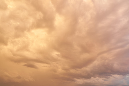 Sky background with reddish clouds in the evening